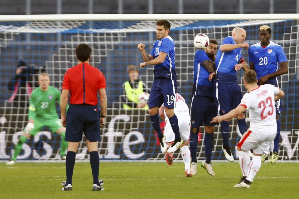 Players of the U.S defend a free kick of Xherdan Shaqiri of Switzerland (R) during their international friendly soccer match at the Letzigrund Stadium in Zurich March 31, 2015. REUTERS/Arnd Wiegmann