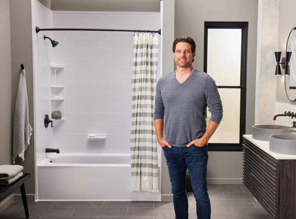 Scott McGillivray stands in a renovated bathroom 