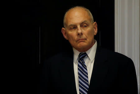 White House Chief of Staff John Kelly listens as U.S. President Donald Trump holds a round table meeting with members of law enforcement about sanctuary cities in the Roosevelt Room at the White House in Washington, U.S., March 20, 2018. REUTERS/Leah Millis