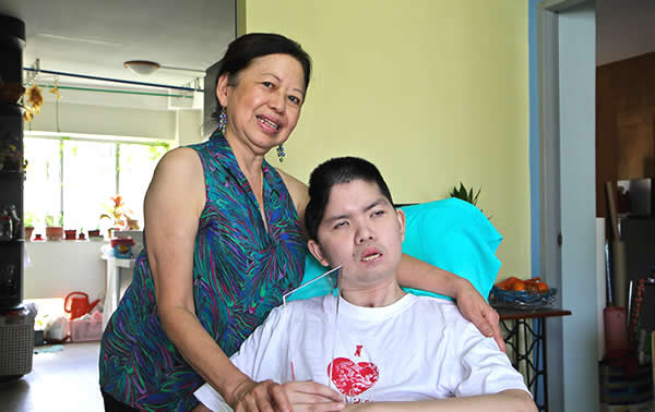 Leong and her son, Clement, holding a World Vision award for outstanding child sponsors. (Yahoo! photo)