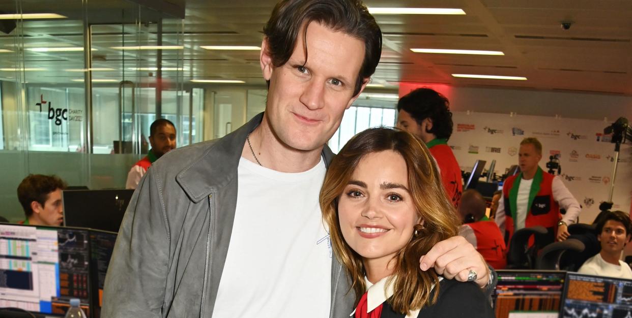 matt smith puts his arm around jenna coleman as they both smile for the camera