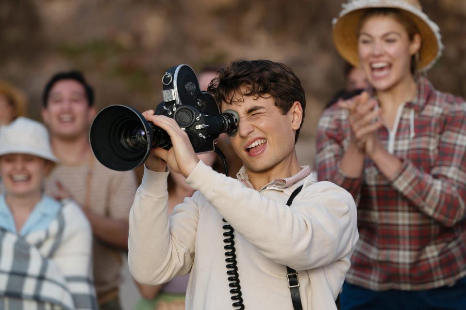 Gabriel LaBelle holds a camera up to his eye