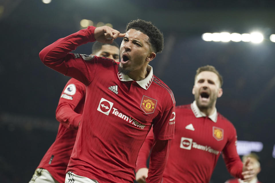 Manchester United's Jadon Sancho celebrates after scoring his sides second goal during the English Premier League soccer match between Manchester United and Leeds United at Old Trafford in Manchester, England, Wednesday, Feb. 8, 2023. (AP Photo/Dave Thompson)