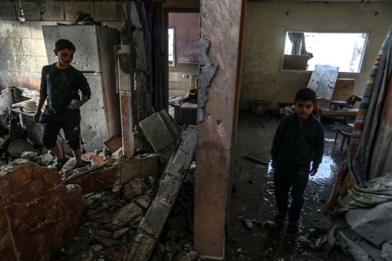 Palestinian boys inspect their home that was damaged after an Israeli air strike on the Shaboura refugee camp. Abed Rahim Khatib/dpa