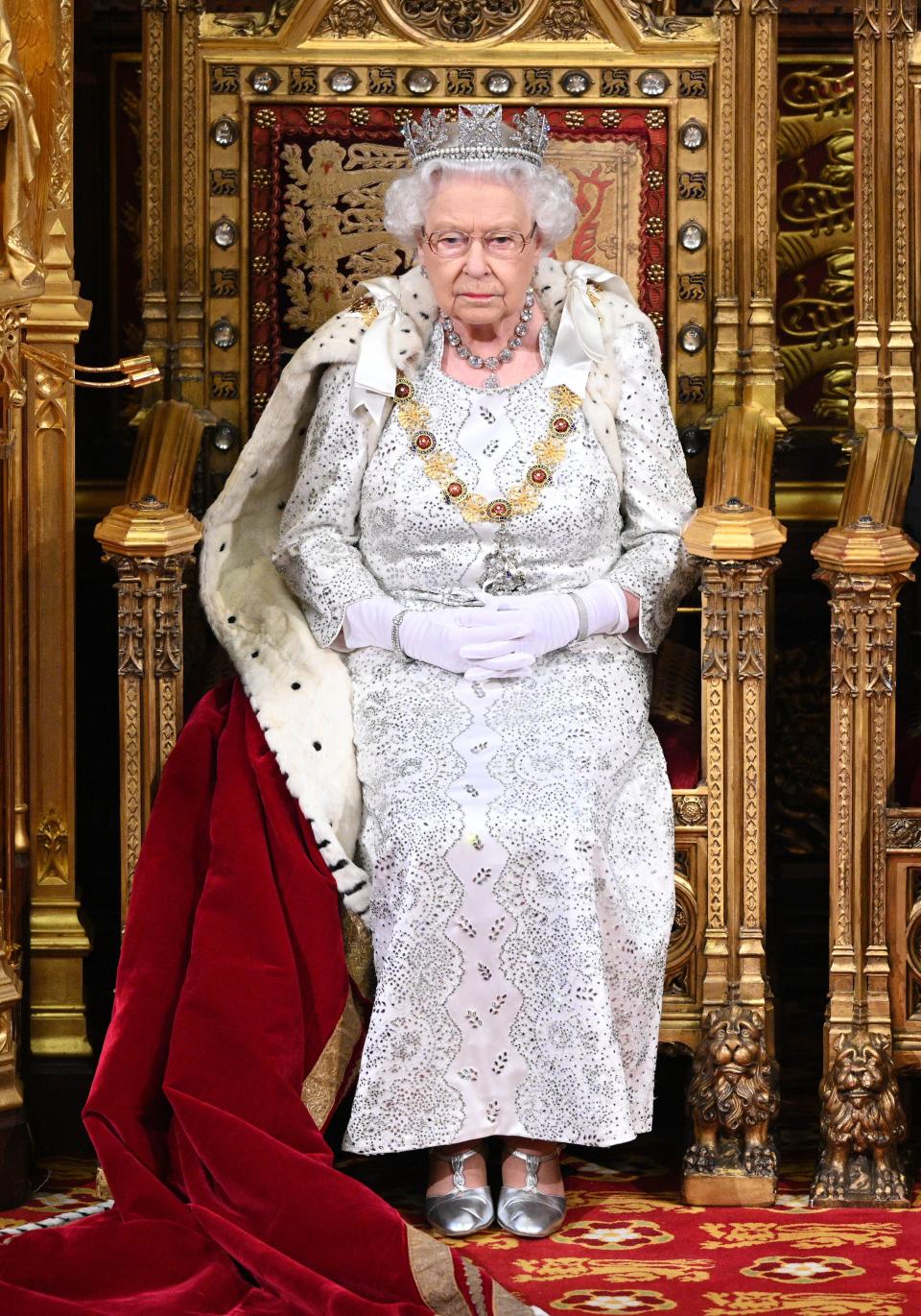 Britain's Queen Elizabeth II takes her seat on the The Sovereign's Throne in the House of Lords at the State Opening of Parliament in the Houses of Parliament in London on October 14, 2019. - The State Opening of Parliament is where Queen Elizabeth II performs her ceremonial duty of informing parliament about the government's agenda for the coming year in a Queen's Speech. (Photo by Paul Edwards / POOL / AFP) (Photo by PAUL EDWARDS/POOL/AFP via Getty Images)