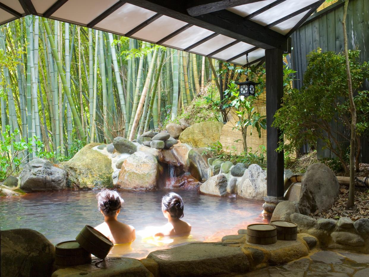 Women bathing in an outdoor pool at Yumotoso - a hot spring resort in Kurokawa Onsen.