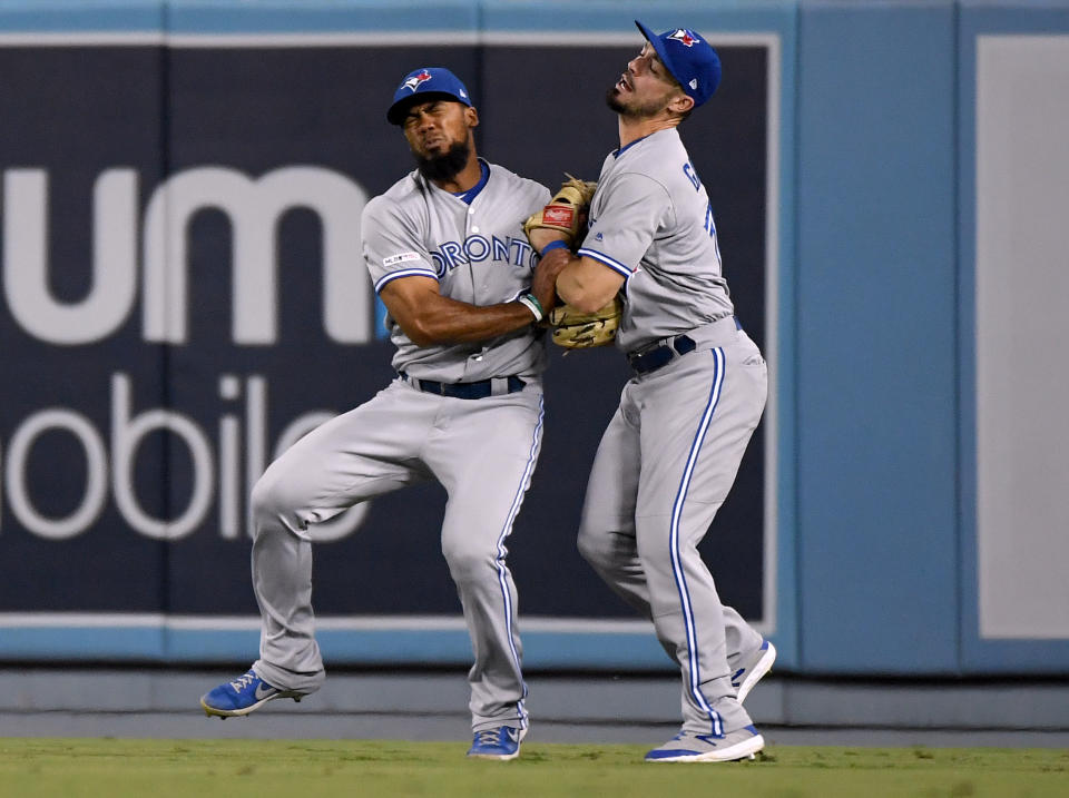 LOS ANGELES, CALIFORNIA - AUGUST 21:  Teoscar Hernandez #37 and Randal Grichuk #15 of the Toronto Blue Jays collide after missing a catch on a ball hit by Chris Taylor #3 of the Los Angeles Dodgers during the fourth inning at Dodger Stadium on August 21, 2019 in Los Angeles, California. (Photo by Harry How/Getty Images)