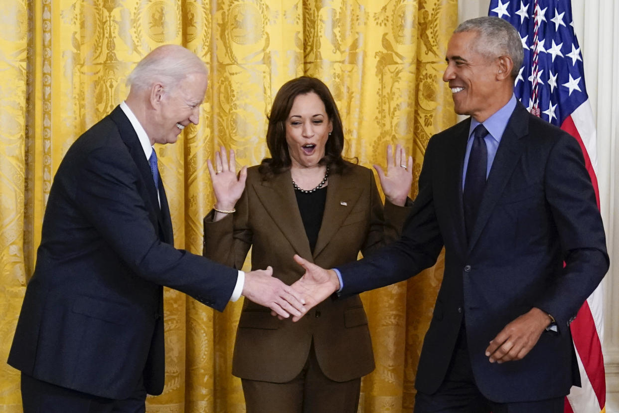 Vice President Kamala Harris reacts as President Biden shakes hands with former President Barack Obama after Obama jokingly called Biden the vice president at the White House on Tuesday. 