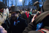 <p>Members of the ‘inner circle’ make their way through crowds during ceremonies for Groundhog Day on Feb. 2, 2018 in Punxsutawney, Pa. (Photo: Brett Carlsen/Getty Images) </p>