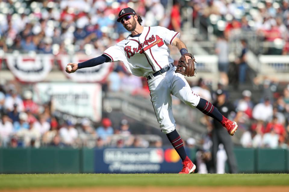 Shortstop Dansby Swanson fields the ball and gets set to throw to first base during an NLDS game against the Phillies at Truist Park in Atlanta on Oct. 11, 2022.