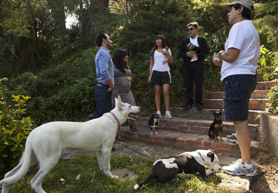 In this photo taken Friday, May 11, 2012, entrepreneurs Aaron and Karine Hirschhorn, far left, interview with "Paw Hills" pet resort owners, the Sorrentini family right, at their home in Woodland Hills area of Los Angeles. Dog Vacay brings together responsible dog lovers with casual and professional dog sitters to provide an affordable experience for pets. (AP Photo/Damian Dovarganes)