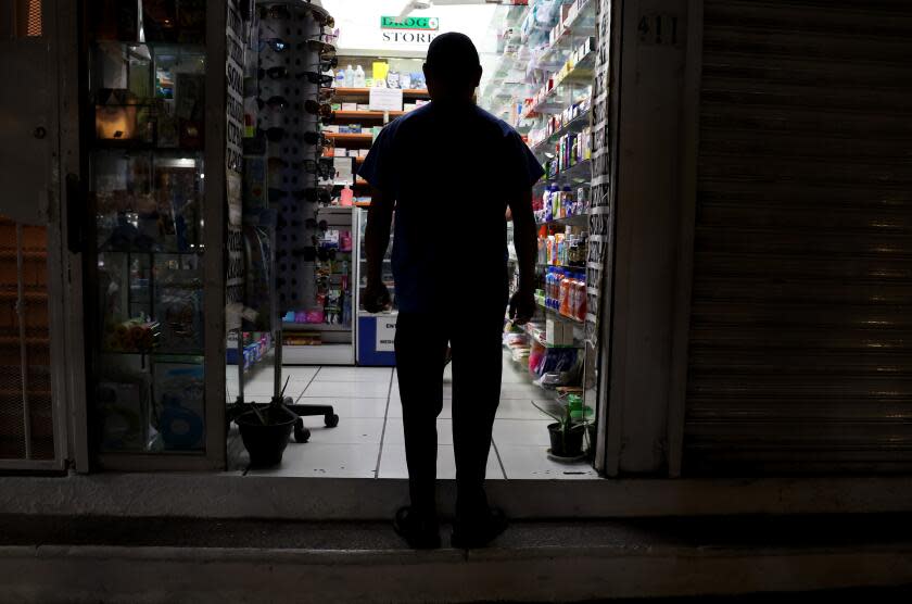 Puerto Vallarta, Mexico December 5, 2023-People walk by a pharmacy in the Zona Romantica district of Puerto Vallarta, Mexico. (Wally Skalij/Los Angeles Times)