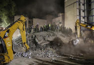 <p>Rescue workers search for people trapped in a collapsed building in the Piedad Narvarte neighborhood of Mexico City, Tuesday, Sept. 19, 2017. A magnitude 7.1 earthquake has stunned central Mexico, killing more than 100 people as buildings collapsed in plumes of dust. Thousands fled into the streets in panic, and many stayed to help rescue those trapped. (AP Photo/Rebecca Blackwell) </p>