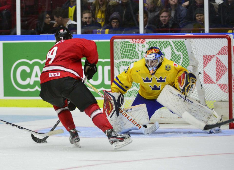 Switzerland's Flavio Schmutz in front of Sweden's goalkeeper Oscar Dansk during their IIHF World Junior Hockey Championship ice hockey game in Malmo December 26, 2013. REUTERS/Ludvig Thunman/TT News Agency (SWEDEN - Tags: SPORT ICE HOCKEY) ATTENTION EDITORS - THIS IMAGE WAS PROVIDED BY A THIRD PARTY. THIS PICTURE IS DISTRIBUTED EXACTLY AS RECEIVED BY REUTERS, AS A SERVICE TO CLIENTS. SWEDEN OUT. NO COMMERCIAL OR EDITORIAL SALES IN SWEDEN. NO COMMERCIAL SALES