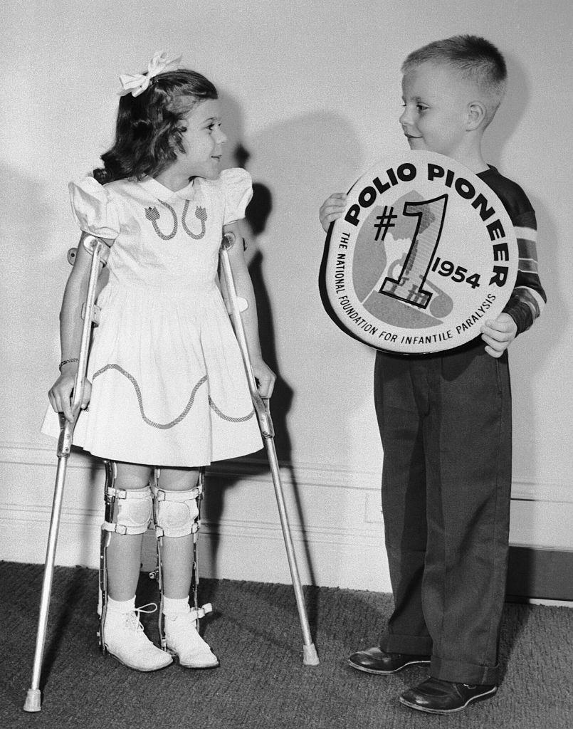 (Original Caption) Five-year old Mary Kosloski, 1955 March of Dimes Poster girl from Collierville, Tennessee, meets seven year old Randy Kerr, of Falls Church, VA., the nation’s first polio pioneer to receive the Salk vaccine during field trials last Spring. Together, Mary and Randy represent the two aims of the March of Dimes-polio treatment and prevention. The annual nationwide drive for funds is scheduled for January 3rd through 31st. (Getty Images)