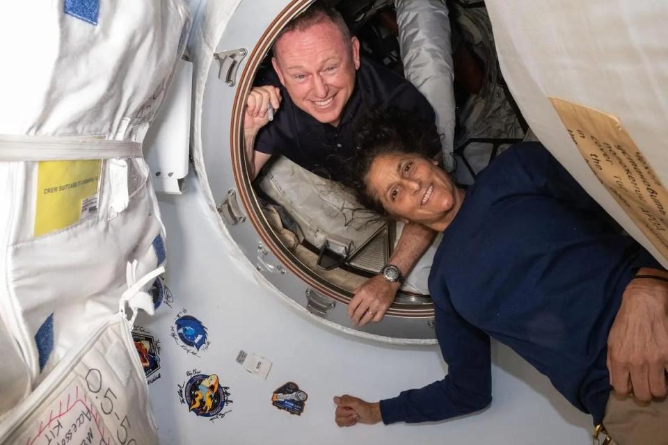 Astronauts Butch Wilmore and Suni Williams pose on June 13, 2024 inside the vestibule between the forward port on the International Space Station’s Harmony module and Boeing’s Starliner spacecraft (Credit: Nasa)