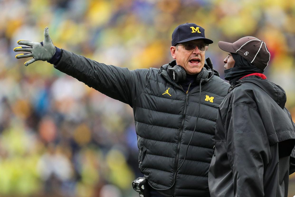 Michigan coach Jim Harbaugh talks to referee regarding a play against Indiana during the first half of U-M's 52-7 win over Indiana on Saturday, Oct. 14, 2023, in Ann Arbor.