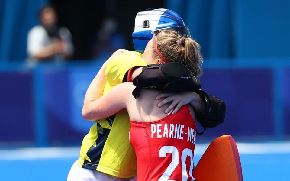 Hollie Pearne-Webb and Maddie Hinch embrace after the match - the pair were crucial members of the gold medal-inning side in Rio and their experience proved key in Tokyo - REUTERS
