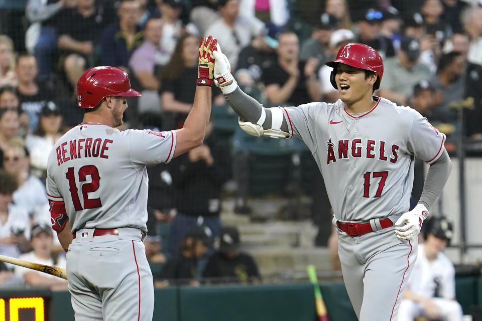 Los Angeles Angels' Shohei Ohtani celebrates his home run off Chicago White Sox starting pitcher Lucas Giolito with Hunter Renfroe during the fourth inning of a baseball game Tuesday, May 30, 2023, in Chicago. (AP Photo/Charles Rex Arbogast)