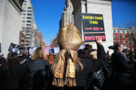 <p>A protester wears a papal tiara and holds up a sign during the “Mock Funeral for Presidents’ Day” rally at Washington Square Park in New York City on Feb. 18, 2017. (Gordon Donovan/Yahoo News) </p>