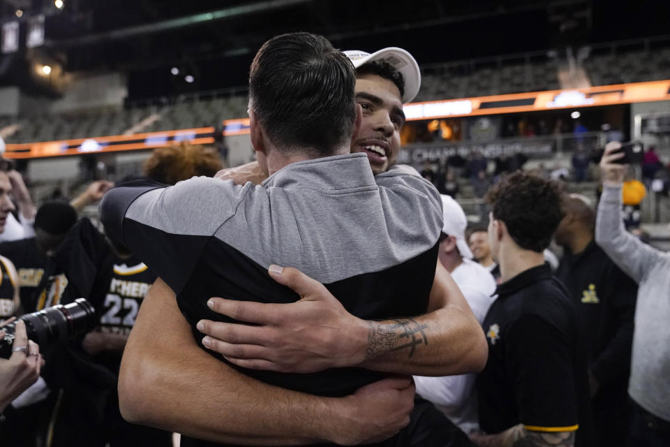 Northern Kentucky's Xavier Rhodes celebrates with coach Darrin Horn following the team's NCAA college basketball game against Cleveland State for the Horizon League men's tournament championship Tuesday, March 7, 2023, in Indianapolis. Northern Kentucky won 63-61. (AP Photo/Darron Cummings)