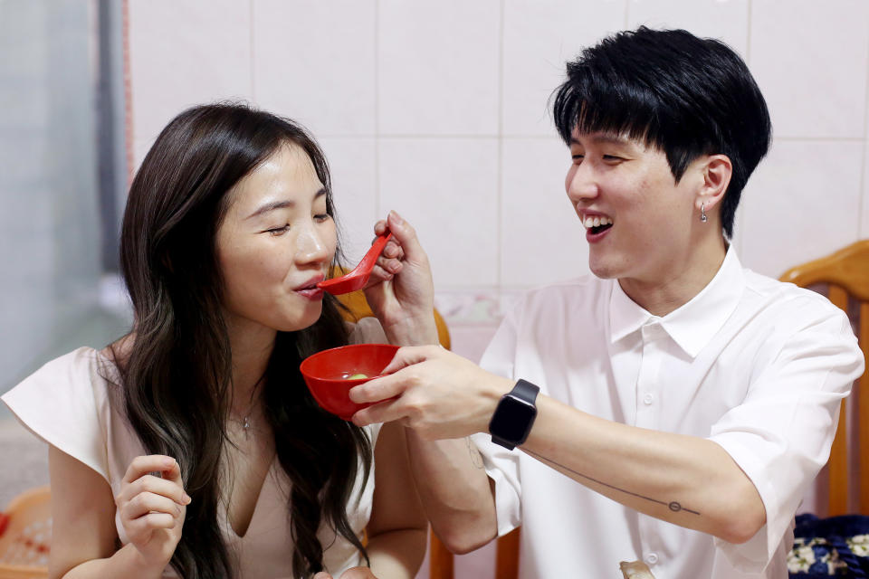 A man feeding a woman from a bowl