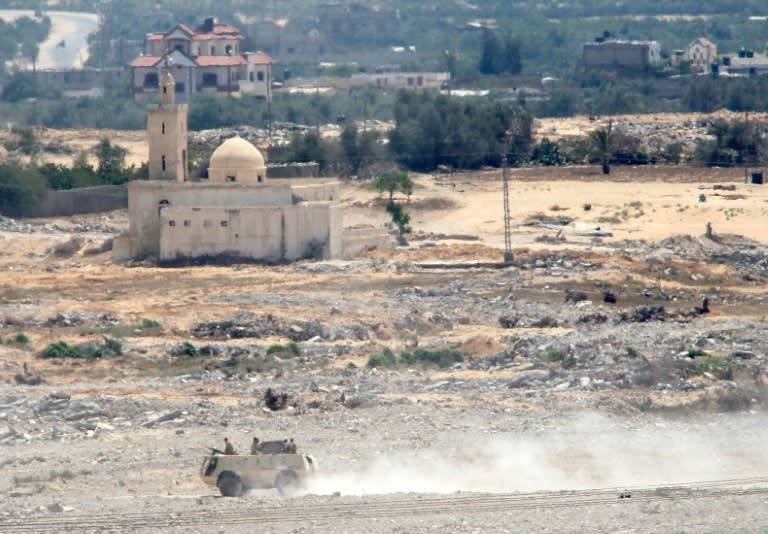 A picture taken in Rafah in the southern Gaza Strip, on the border with Egypt, shows an Egyptian armored vehicle patroling the area on the Egyptian side of the border on July 2, 2015