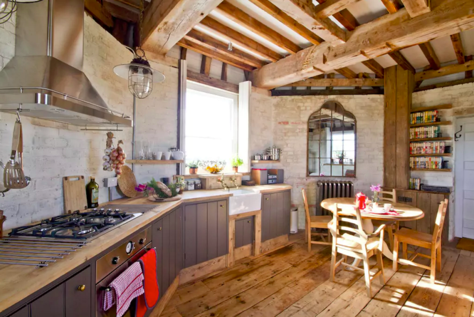 <p>The kitchen has plenty of rustic charm with its wooden floors and beamed ceiling. (Airbnb) </p>