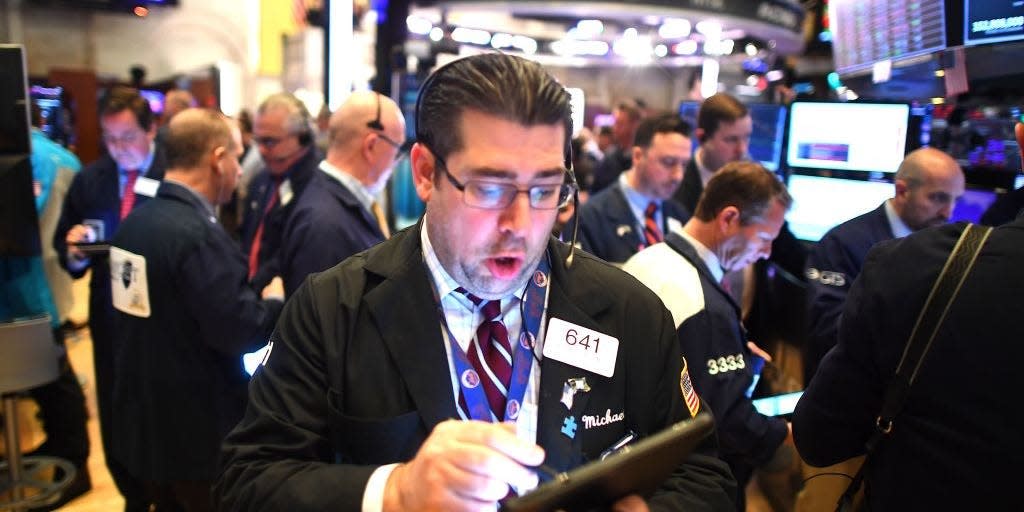 Traders work during the opening bell at the New York Stock Exchange (NYSE)