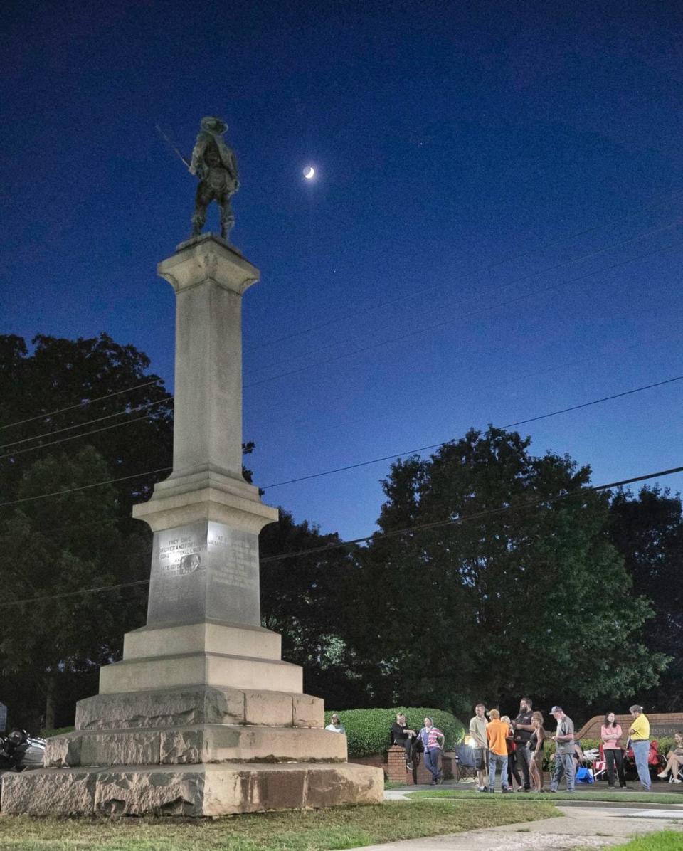 Part of a group of nearly 20 Franklin County residents that gather nightly on N. Main Street to keep watch over the Confederate monument in downtown Louisburg after the town council voted on Monday night to move the monument to a cemetery. The monument has stood for 106 years on N. Main Street in the middle of the Louisburg College campus. By 10 p.m. more than 20 people, mostly Sons of Confederate Veterans and United Daughters of the Confederacy members gathered to protect the monument from vandalism.