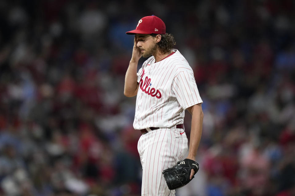 Philadelphia Phillies pitcher Aaron Nola wipes his face after giving up a three-run home run to Detroit Tigers' Nick Maton during the seventh inning of a baseball game, Monday, June 5, 2023, in Philadelphia. (AP Photo/Matt Slocum)