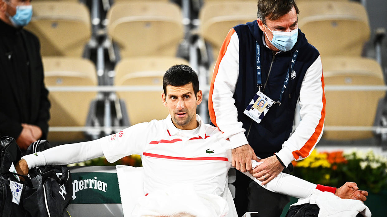 Novak Djokovic is pictured getting treatment on his shoulder during a medical timeout at the French Open. 