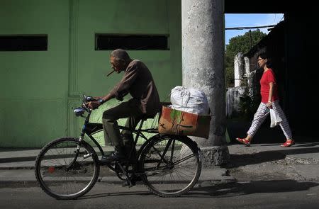 A man rides his bicycle in Havana December 27, 2014. REUTERS/Stringer