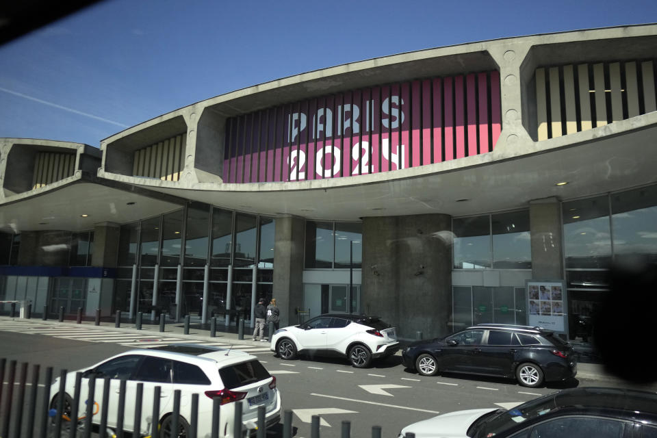Paris 2024 is painted on the facade of Charles de Gaulle airport, terminal 1, in Roissy-en-France, north of Paris, Tuesday, April 23, 2024 in Paris. (AP Photo/Thibault Camus)