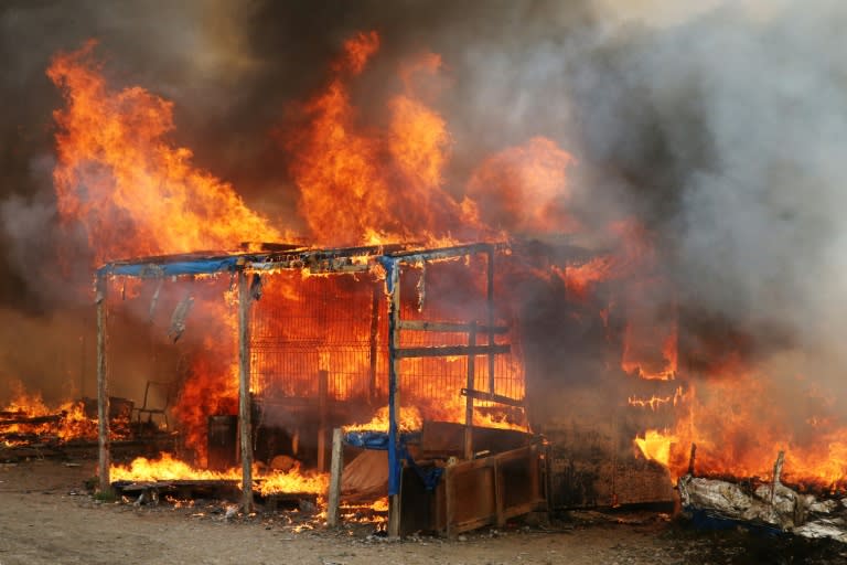 Fires tore through many of the makeshift shelters at the "Jungle" migrant camp in Calais, northern France