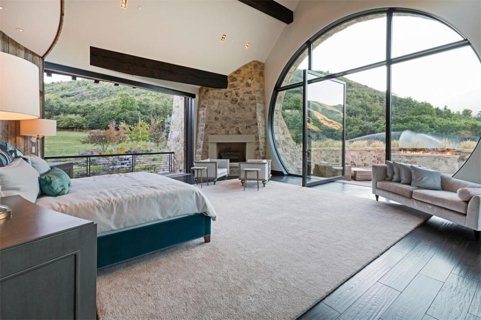 <p>The main bedroom, one of six in the property, has fantastic panoramic views through an enormous arched window at the foot of the bed. </p>