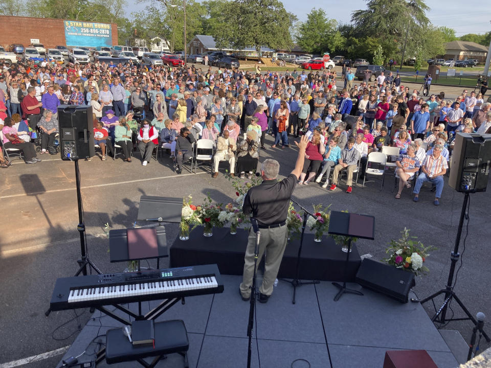 A pastor prays for shooting victims in Dadeville, Ala., at a vigil in the parking lot of First Baptist Church, Sunday, April 16, 2023. (AP Photo/Jeff Amy)