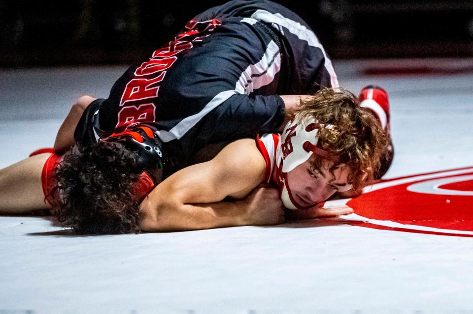 New Bedford's Luis Garcia looks to get out from under Brockton's Aiden Rivera.