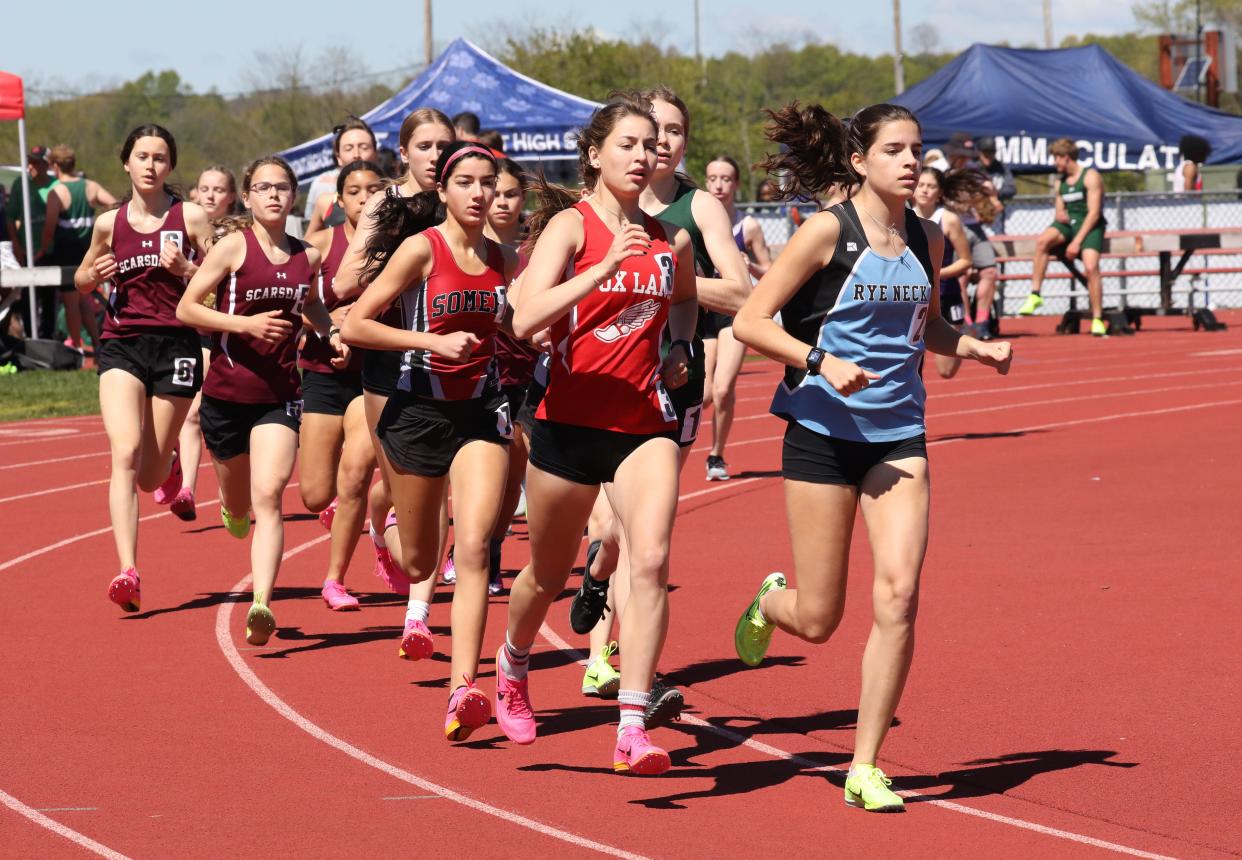 Rye Neck's Ainara Schube Barriola leads Fox Lane's Morgan Eigel (who now runs for Williams College), Somers' Julia Aquilino and the rest of the pack during the girls 3,000 at the 45th annual Joe Wynne Somers Lions Club Invitational at Somers High School, May 6, 2023.