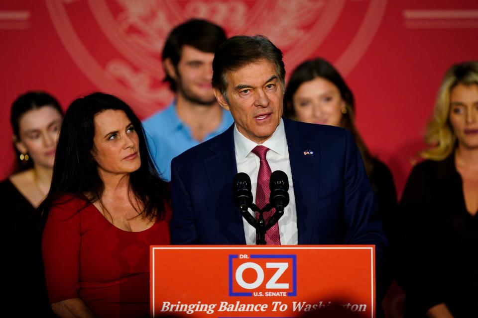 Mehmet Oz, the Republican candidate for U.S. Senate in Pennsylvania, speaks to supporters at an election night rally in Newtown, Pa., Tuesday, Nov. 8, 2022, as his wife Lisa listens.