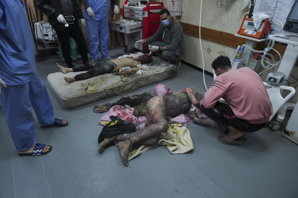 Palestinians wounded in the Israeli bombardment of the Gaza Strip are brought to the hospital in Deir al Balah on Sunday, Dec. 3, 2023. (AP Photo/ Hatem Moussa)