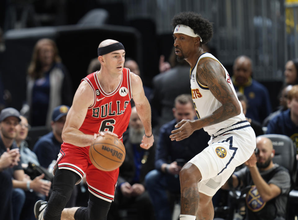 Chicago Bulls guard Alex Caruso, left, drives past Denver Nuggets guard Kentavious Caldwell-Pope in the first half of an NBA basketball game Wednesday, March 8, 2023, in Denver. (AP Photo/David Zalubowski)