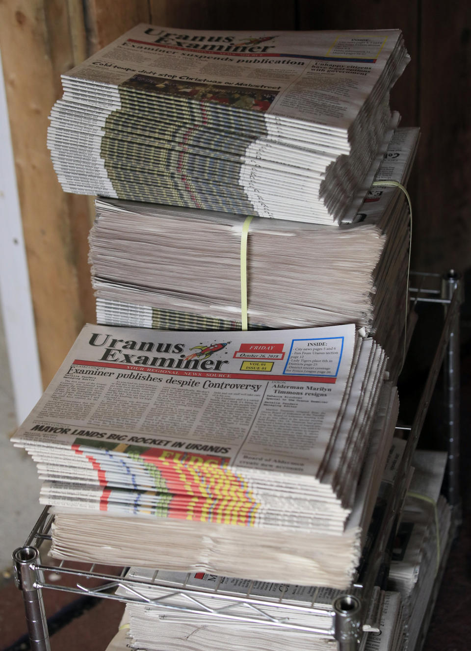 This Feb. 20, 2019 photo shows old copies of the Uranus Examiner stacked in the paper's office near St. Robert, Mo. Only five editions of the paper were printed. (AP Photo/Orlin Wagner)