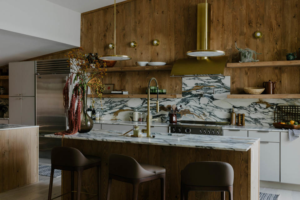 Nautical details, like bezel sconces, nod to the home’s location on the water, while Bellagio kitchen stools by Morelato continue the theme of low-profile furniture.