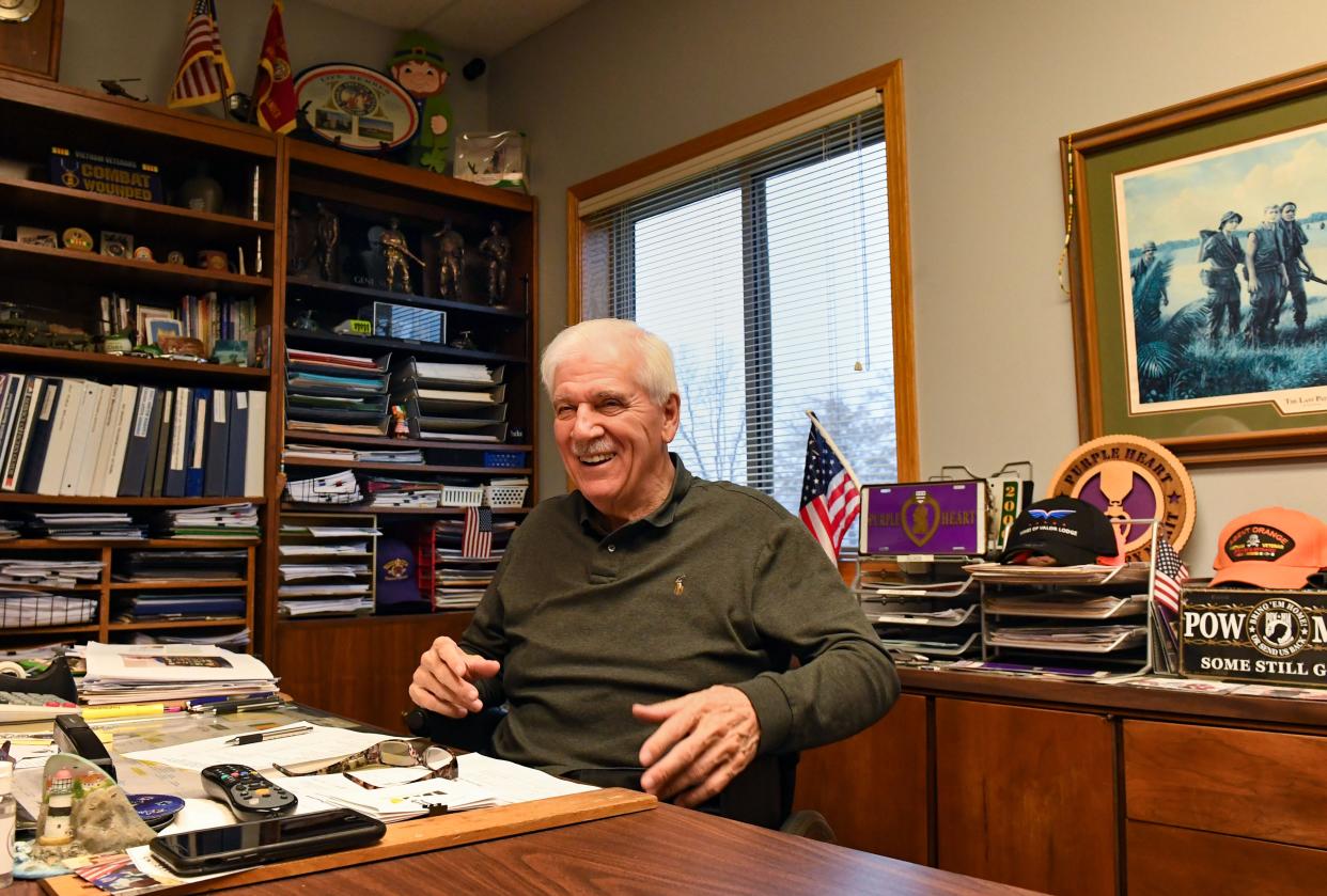 Gene Murphy laughs while telling a story on Wednesday, November 10, 2021, at his desk at the Disabled American Veterans office in Sioux Falls. Murphy, a Vietnam War veteran, said he is a bit of a collector, with military memorabilia, challenge coins and pieces of art lining the shelves of his office.