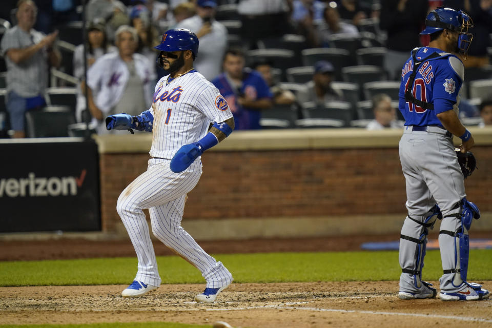 New York Mets' Jonathan Villar (1) runs past Chicago Cubs catcher Willson Contreras (40) to score during the fifth inning of a baseball game Tuesday, June 15, 2021, in New York. (AP Photo/Frank Franklin II)