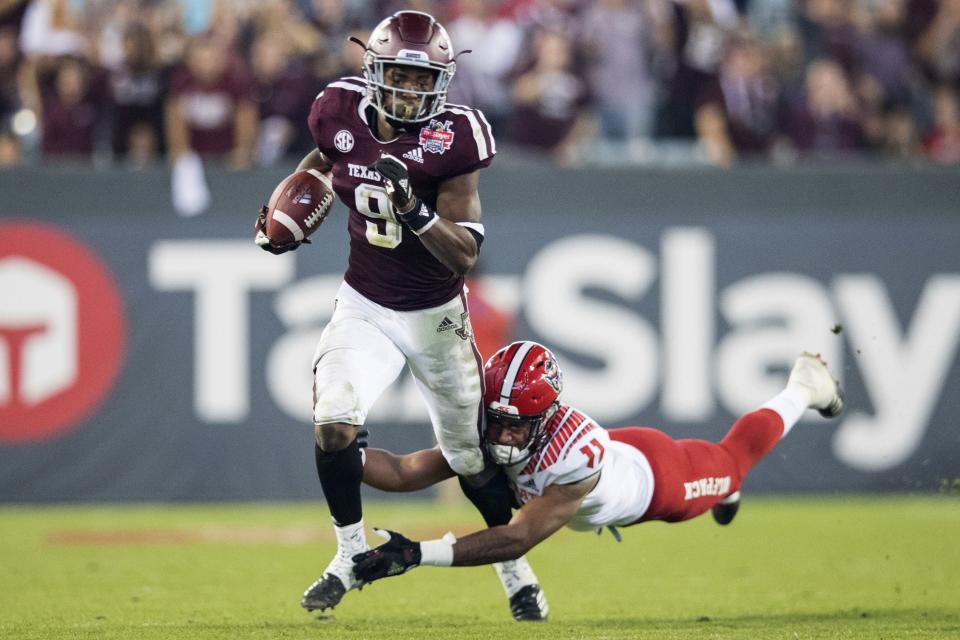 Texas A&M defensive back Leon O'Neal Jr. (9) is tackled by North Carolina State wide receiver Jakobi Meyers after an interception during the first half of the Gator Bowl NCAA college football game Monday, Dec. 31, 2018, in Jacksonville, Fla. (James Gilbert/The Florida Times-Union via AP)