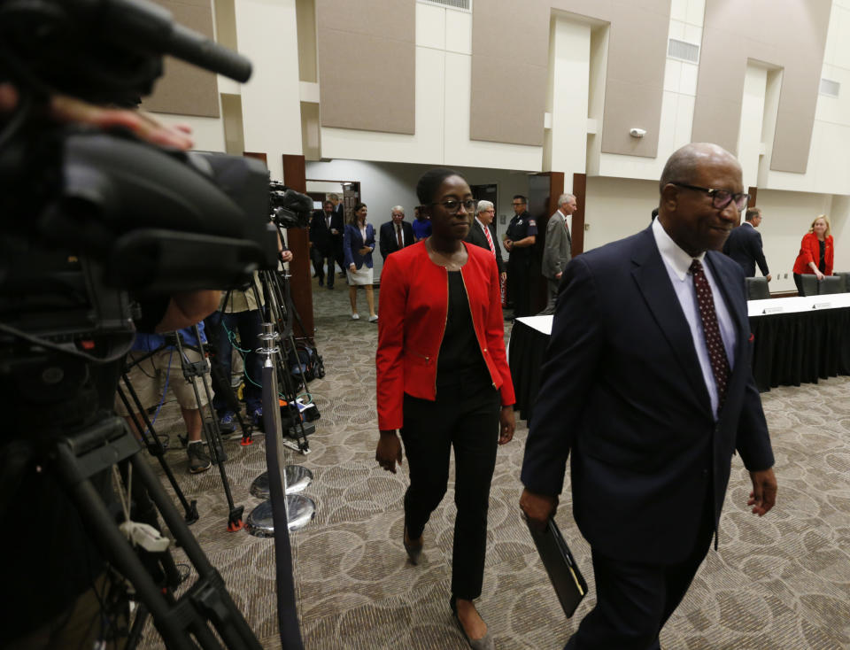 Ohio State university board of trustees members Alex Shumate, right, and Janice Bonsu enter a meeting of the trustees to discuss the future of NCAA college football coach Urban Meyer in Columbus, Ohio, Wednesday, Aug. 22, 2018. The board will meet in private to decide whether the superstar coach should be punished for the way he handled domestic-abuse allegations against a former assistant. (AP Photo/Paul Vernon)