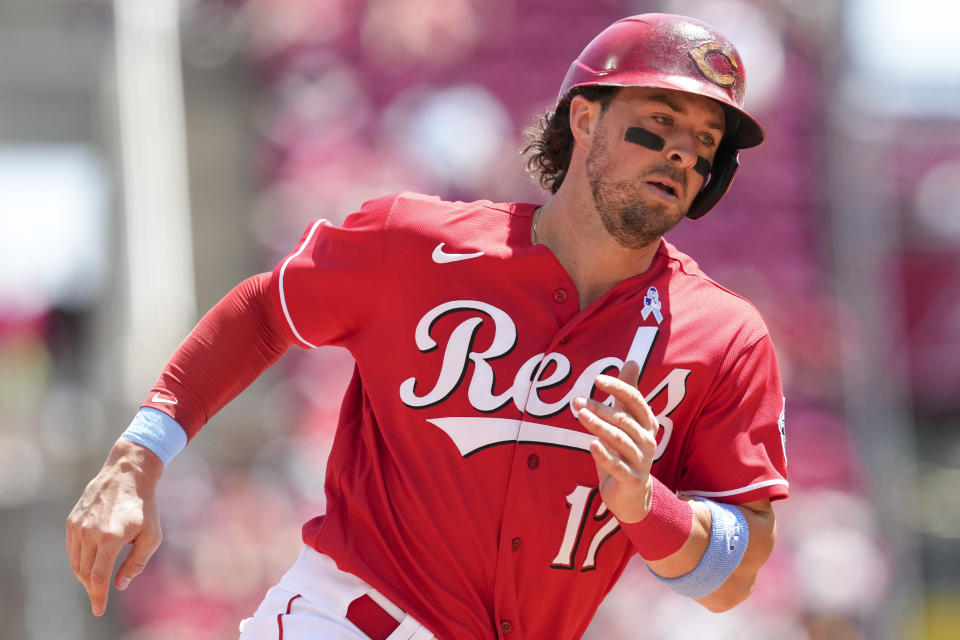 Cincinnati Reds' Kyle Farmer (17) rounds third base on his way to scoring on a two-run double hit by Albert Almora Jr. during the fourth inning of a baseball game against the Milwaukee Brewers, Sunday, June 19, 2022, in Cincinnati. (AP Photo/Jeff Dean)