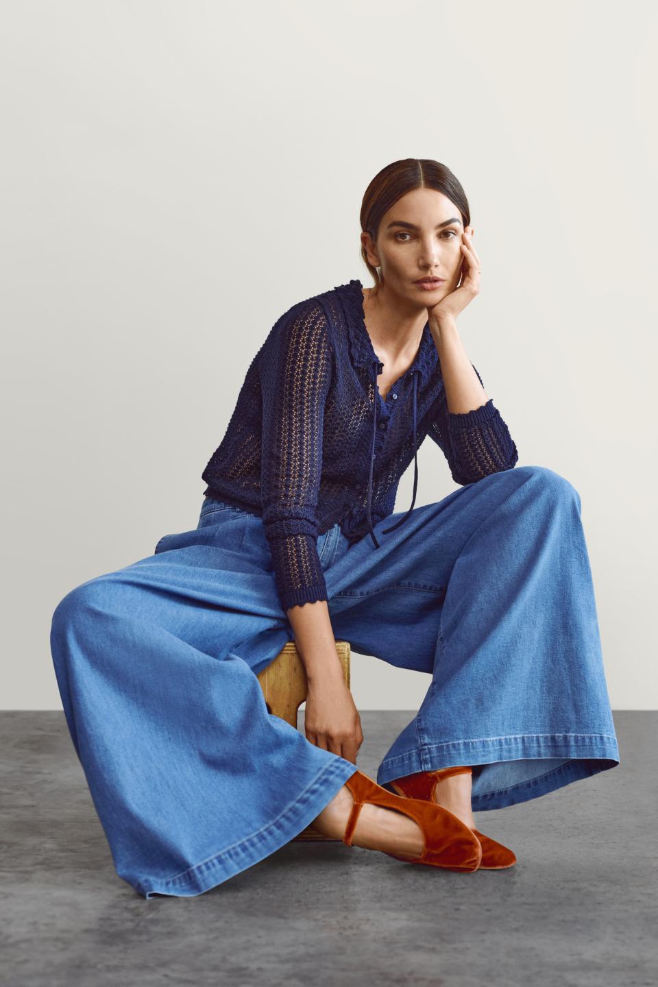 Lily Aldridge wears the Gap x Doen collaboration while sitting in front of a plain backdrop